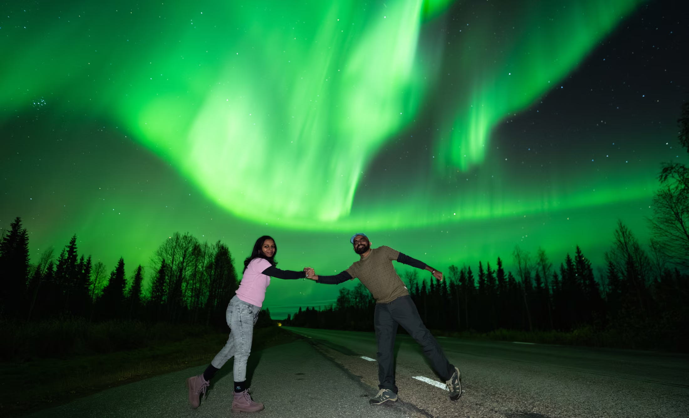 A couple dancing under the northern lights