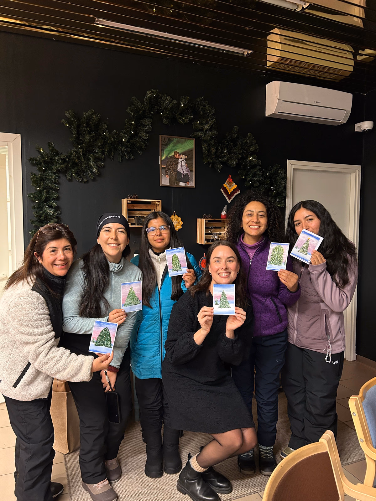 Workshop guests showing their finished hand-painted postcards